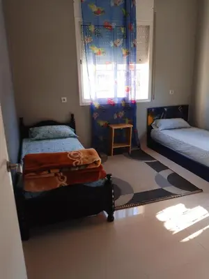 a small bedroom with two beds and a window at إقامة المنظر الجميل in Oulad Akkou