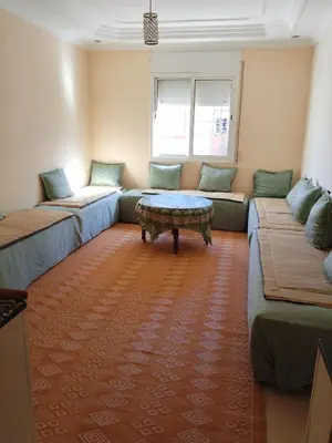 a living room with two couches and a coffee table at إقامة المنظر الجميل in Oulad Akkou