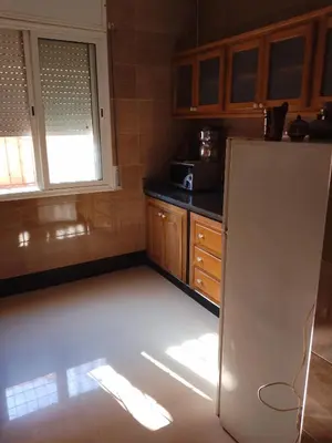 a kitchen with a refrigerator and a window at إقامة المنظر الجميل in Oulad Akkou