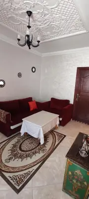 a living room with a couch and a table at Bouznika in Oulad Akkou