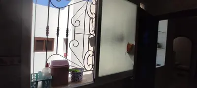 a glass window with a view of a patio at Bouznika in Oulad Akkou