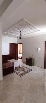 a living room with a bed and a ceiling at Bouznika in Oulad Akkou