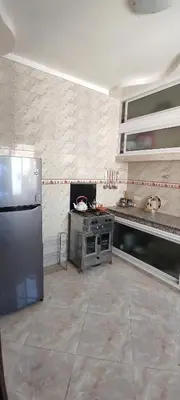 a kitchen with a stainless steel stove and refrigerator at Bouznika in Oulad Akkou
