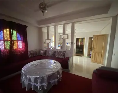 a living room with a couch and a table at Dar Ezzaouiya in Ouzoud