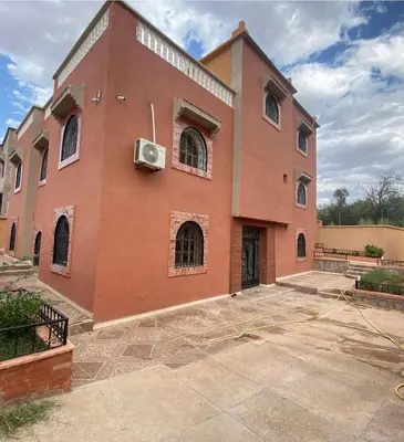 a large brick building with anoxious at Dar Ezzaouiya in Ouzoud