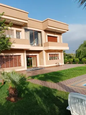 a house with a lawn in front of it at Ferme fes in Oulad Tayeb