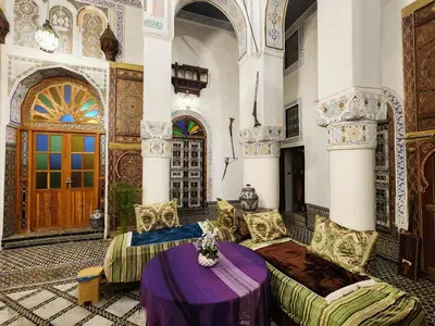 a living room with a purple table in a building at Riad el Anaqa in Fès