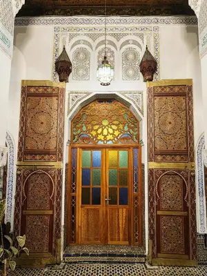 an entrance to a building with a wooden door at Riad el Anaqa in Fès