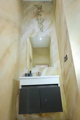 a bathroom with a sink and a mirror at Résidence Meknes Appt F4 in Meknès