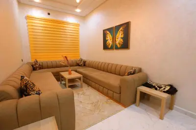 a living room with a large couch and a table at Résidence Meknes Appt F4 in Meknès