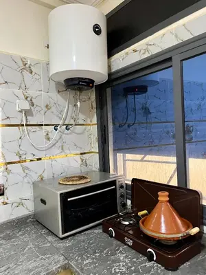 a microwave oven sitting on top of a counter at Saha khedra in Oulad Akkou