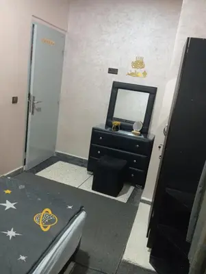 a bathroom with a black dresser and a mirror at الحي المحمدي أكادير in Oulad Akkou