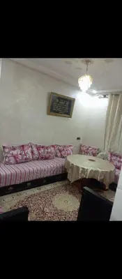 a living room with a couch and a table at الحي المحمدي أكادير in Oulad Akkou
