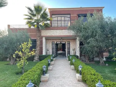 a building with a palm tree in front of it at Exclusive Villa Privée 5 Chambres Route de L Ourika in Sidi Bouzguia