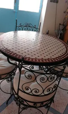 a round table with a patterned table and chairs at Tazouta Farm Villa with Pool in Tazouta