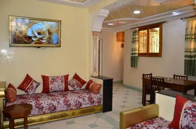 a living room with a couch and a dining room at Appart Porte de la Médina in Fès