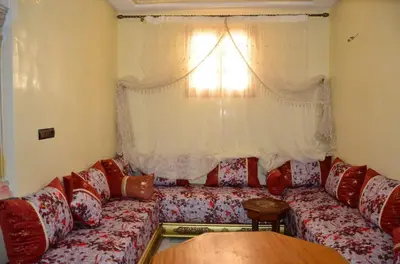 a living room with a couch and a window at Appart Porte de la Médina in Fès