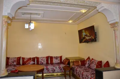 a living room with a couch and a table at Appart Porte de la Médina in Fès