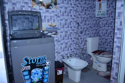 a video game machine in a bathroom with a toilet at Appart Porte de la Médina in Fès