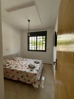 a bedroom with a bed and a window at Saidia Beach appartement in Oulad Akkou