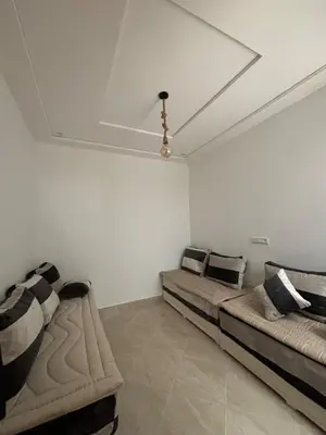 a room with two beds and a ceiling at Saidia Beach appartement in Oulad Akkou