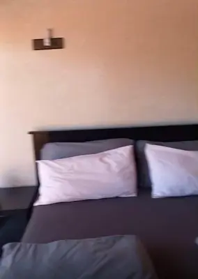 a bedroom with a bed with two white pillows at Villa Mina in Aghmat