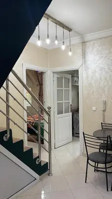 a room with a staircase and a table and chairs at Blange neige in Ifrane