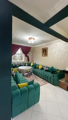 a living room with a green couch and a table at Blange neige in Ifrane