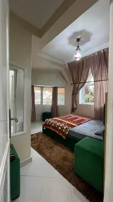 a bedroom with a bed and a large window at Blange neige in Ifrane