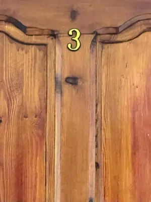 a pair of doors with the number three on them at Residence Kawtar Meknès Marjane 2 in Meknès
