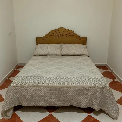 a bed in a bedroom with a bedspread on it at Residence Kawtar Meknès Marjane 2 in Meknès