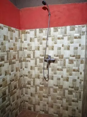 a shower with a shower head in a bathroom at Dar itran 2 in Mhamid