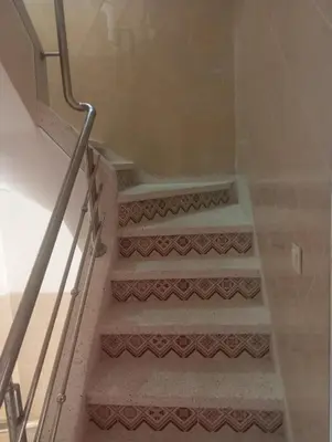 a set of stairs with brown and white tiles at Appartment Dar Immi Medina Your Cozy Oasis in the Heart of Marrakech in Oulad Akkou