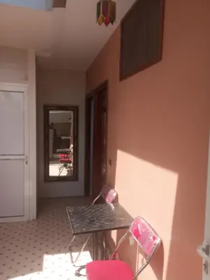 a room with a table and chairs and a mirror at Appartment Dar Immi Medina Your Cozy Oasis in the Heart of Marrakech in Oulad Akkou