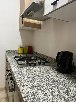 a kitchen with a stove and a counter top at La Joie de Vivre in Oulad Akkou