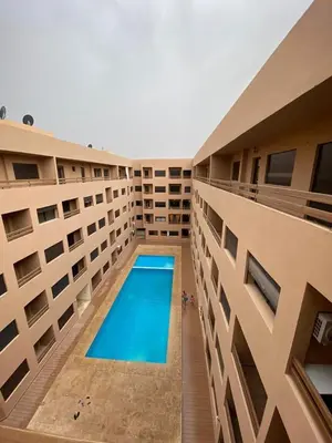 a swimming pool in the middle of a building at La Joie de Vivre in Oulad Akkou