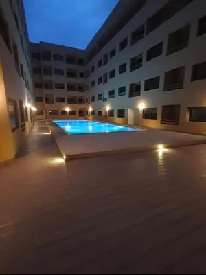 a large swimming pool in a building at night at La Joie de Vivre in Oulad Akkou