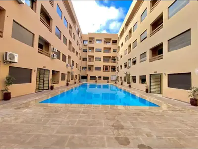 a swimming pool in the middle of a building at La Joie de Vivre in Oulad Akkou