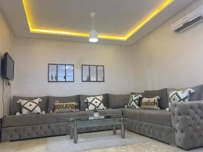 a living room with a couch and a table at La Joie de Vivre in Oulad Akkou