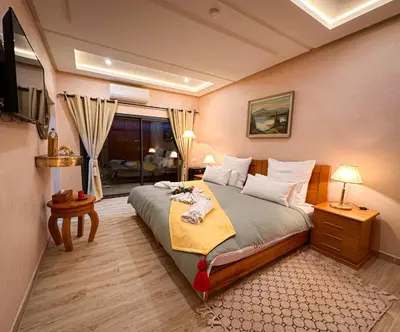 a bedroom with a large bed and a window at Atlas Front in Marrakech
