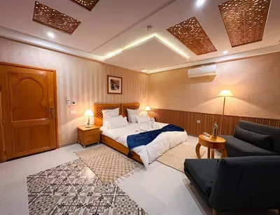 a hotel room with a bed and a couch at Atlas Front in Marrakech