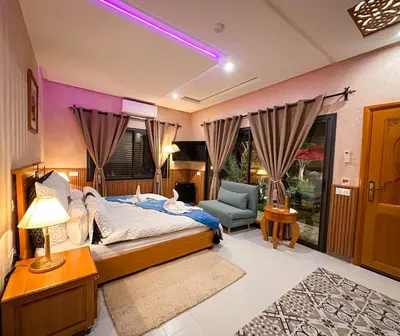 a bedroom with a bed and a couch and a chair at Atlas Front in Marrakech