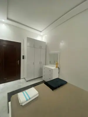 a white room with a bed and a dresser at Unique et strategique in Meknès