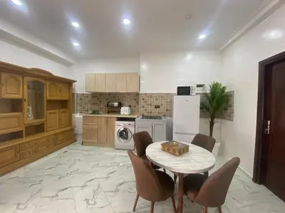 a kitchen with a table and chairs and a refrigerator at Unique et strategique in Meknès