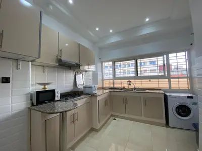 a kitchen with a sink and a washing machine at Unique et strategique in Meknès