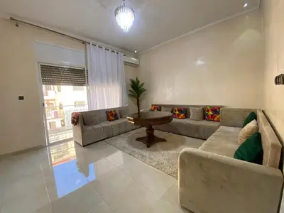 a living room with a couch and a table at Unique et strategique in Meknès
