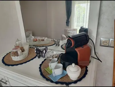 a counter with a coffee maker and cups on it at Maison avec piscine in Oulad Akkou