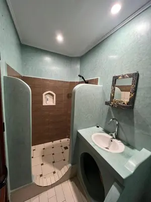 a bathroom with a sink and a mirror at Kasbah Ait Marghad in Aït Ougliff