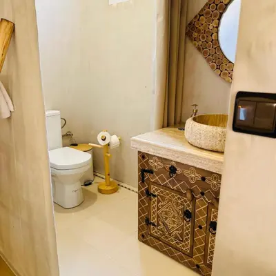 a bathroom with a toilet and a sink at Traveling Luxury Camp in Merzouga