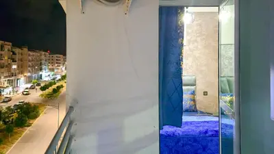 a window with a view of a city at night at Fes Serenity - Appartement Suites Medina in Fès